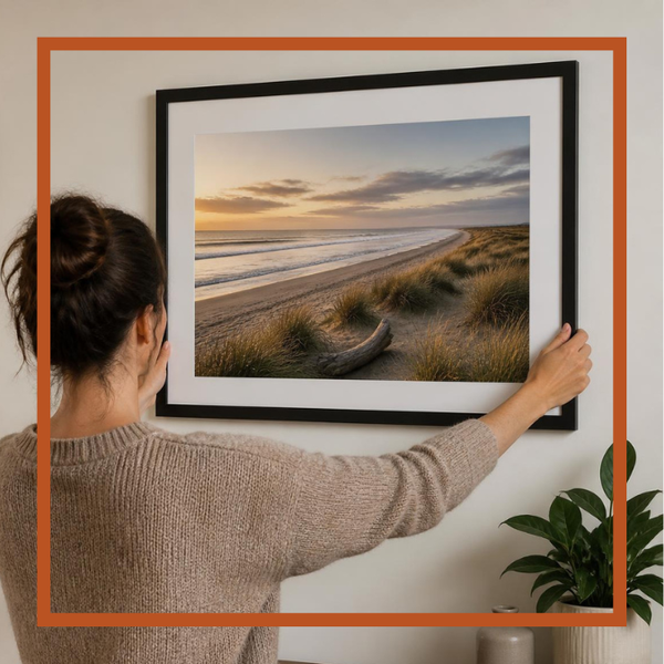 Large poster print being hung on a wall